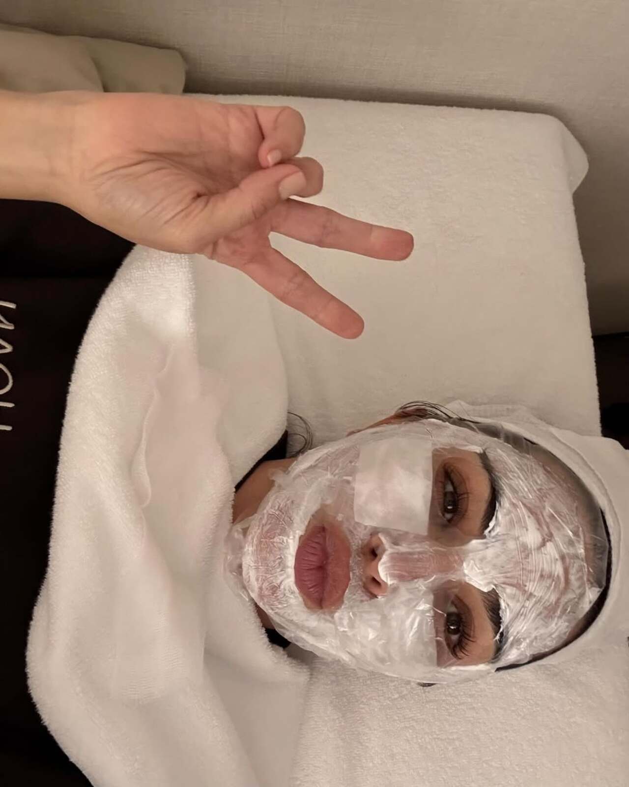 South Korea is known for their cosmetic and plastic surgery with cutting-edge technology. In this picture, Kim Kardashian is seen lying down with a white facial mask covering her entire face.